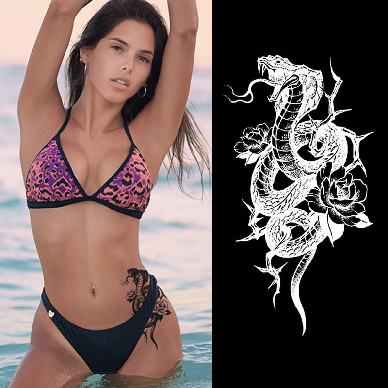 Cobra semi permanent tattoo applied on forearm, realistic snake design.